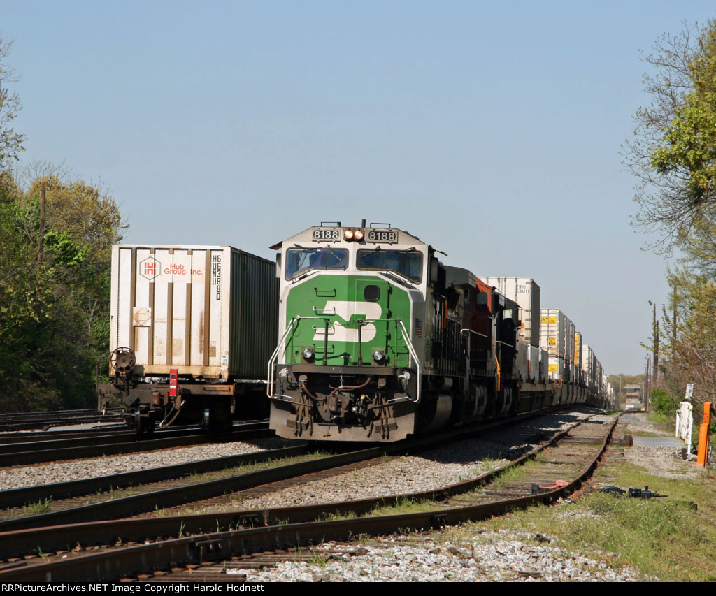 BNSF 8188 leads train 214 past the rear of train 213
